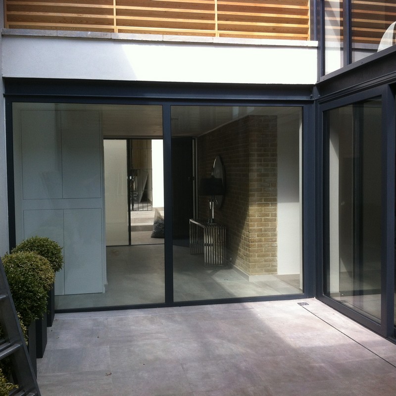 Floor-to-ceiling sliding doors opening to courtyard in Reading