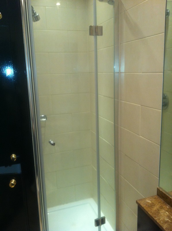 Frameless glass shower enclosure with chrome fittings in Reading
