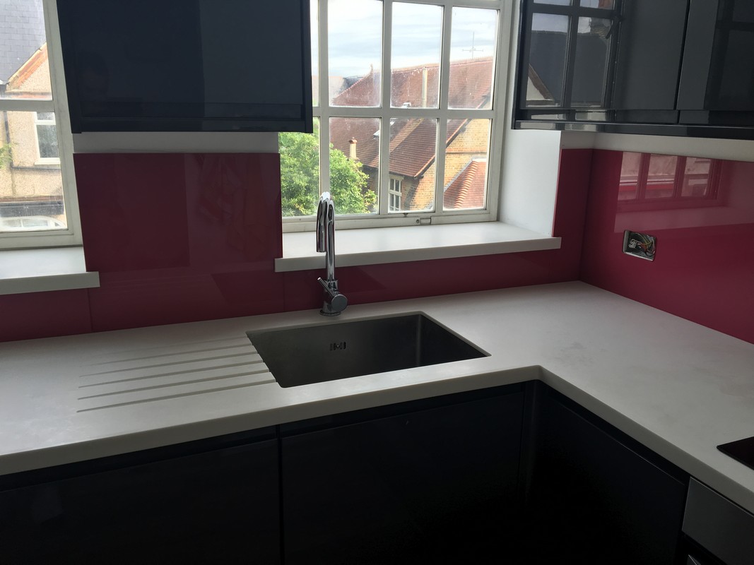 Deep plum coloured glass splashback in modern Reading kitchen