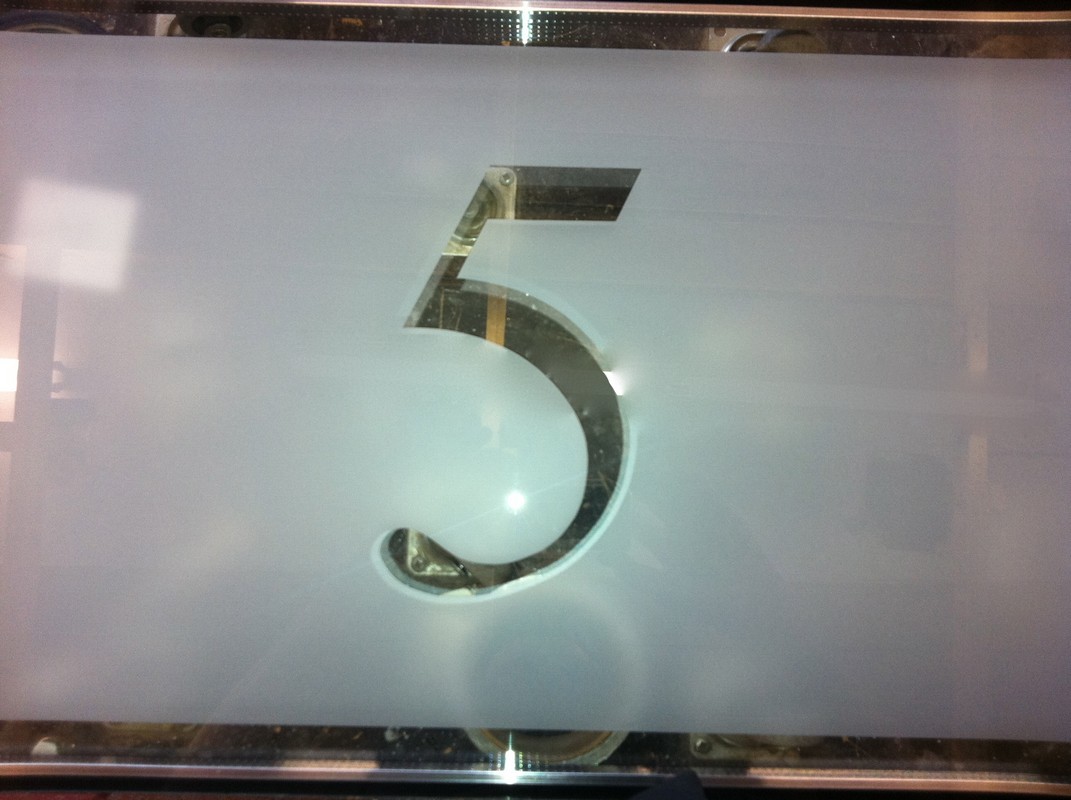 Sandblasted glass panel with cut-out house number design